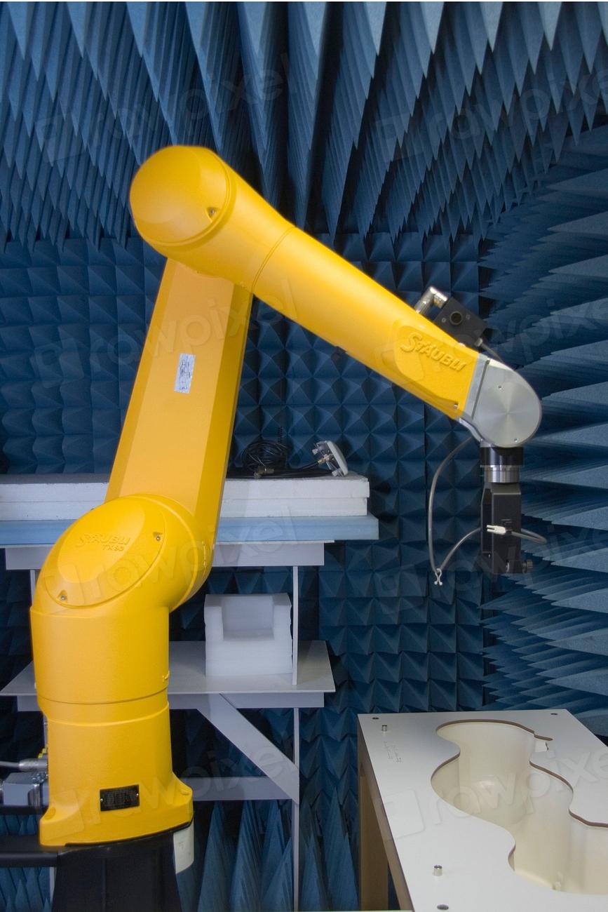 Industrial robot arm in a manufacturing cell