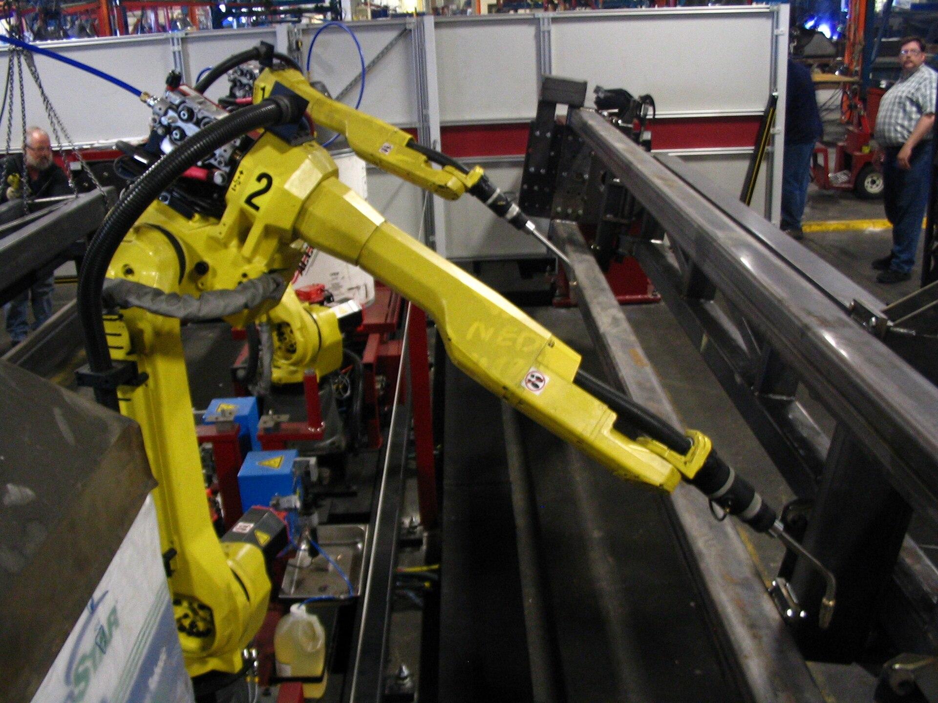 FANUC six-axis industrial robots on a production line