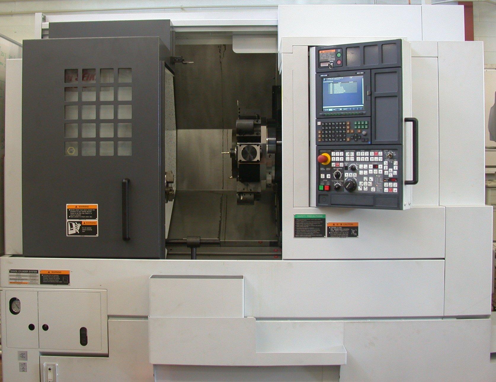 CNC lathe with its control panel showing a program listing