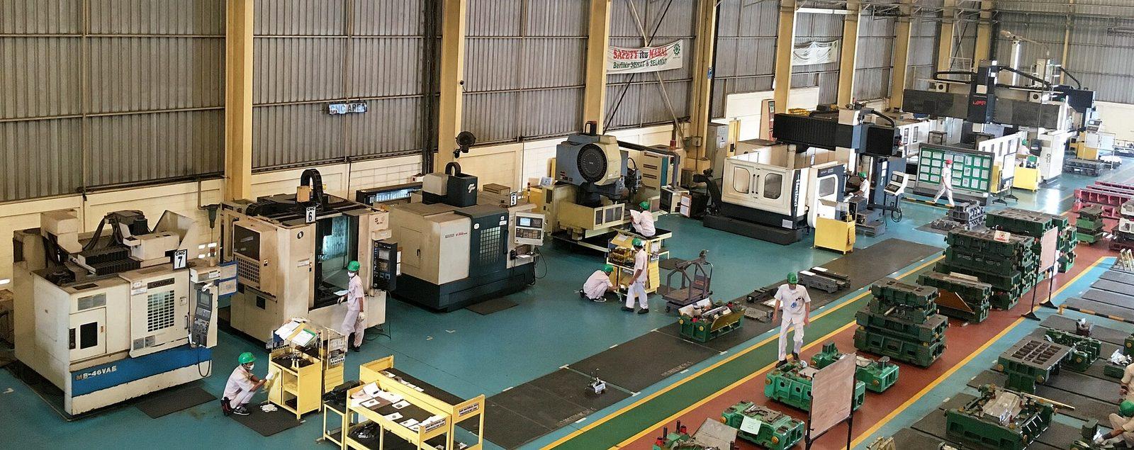 A machine shop floor lined with CNC machining centres