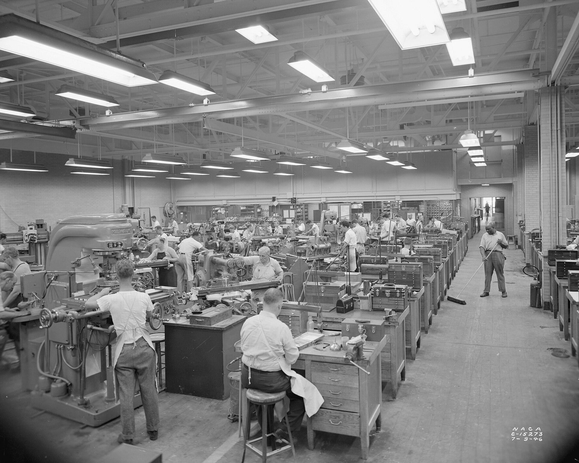 Rows of milling machines and machinists in the NACA machine shop, 1946
