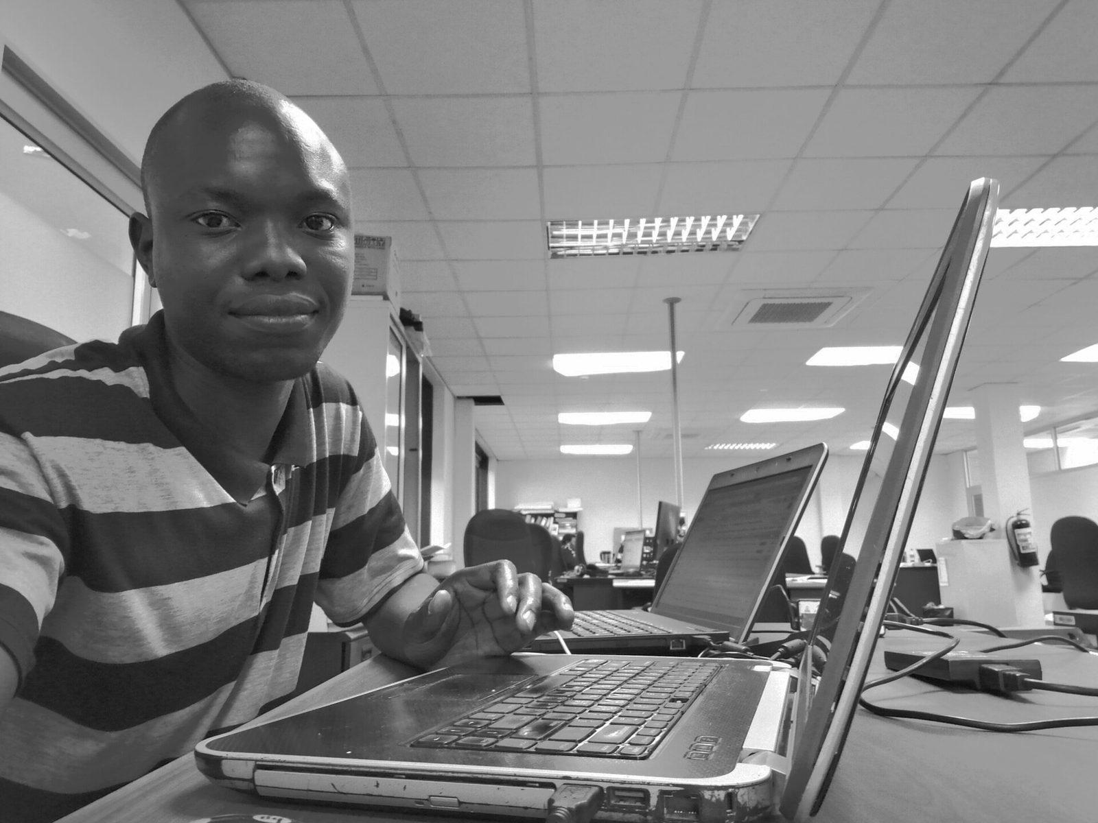 An engineer working at a laptop in an office