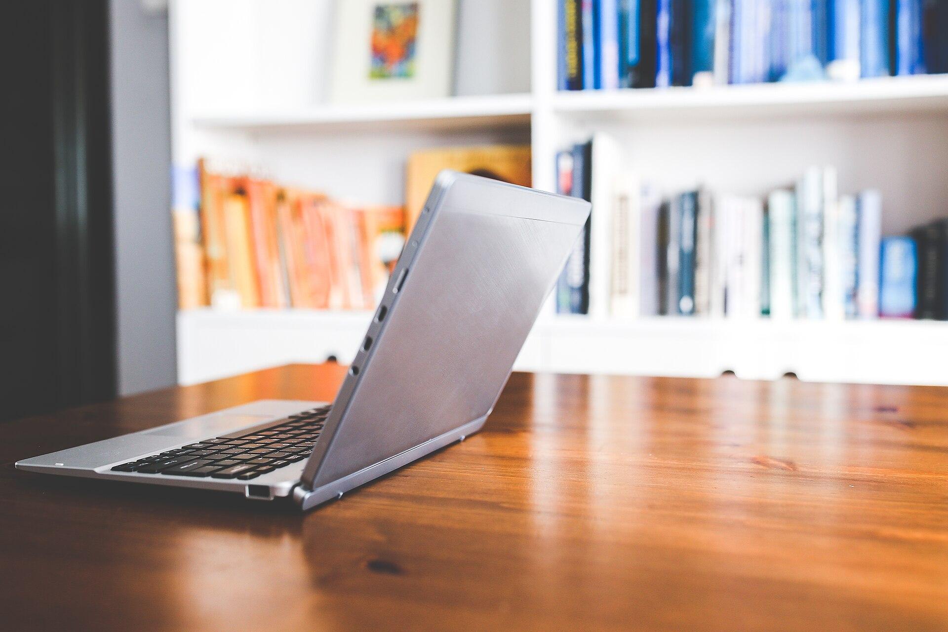 Laptop and notebook on a work desk